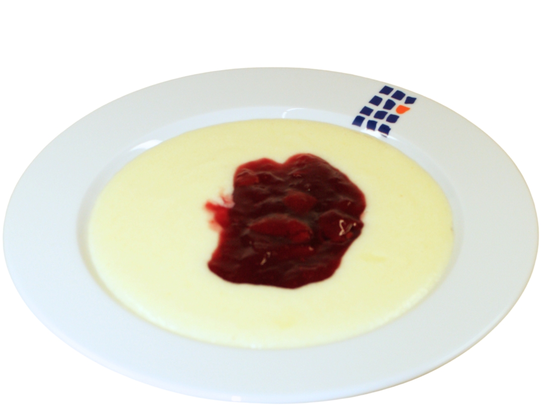 Teller Grießbrei mit heißen Sauerkirschen